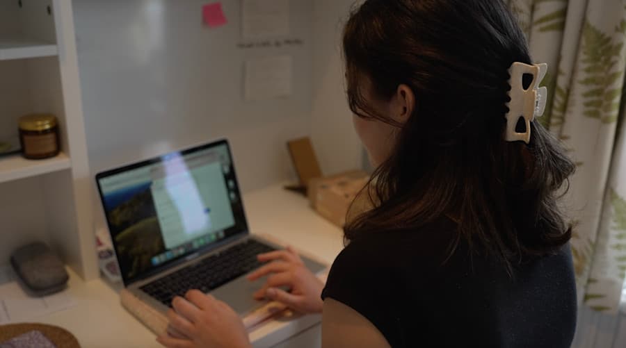 Carly Hewett is on the computer.