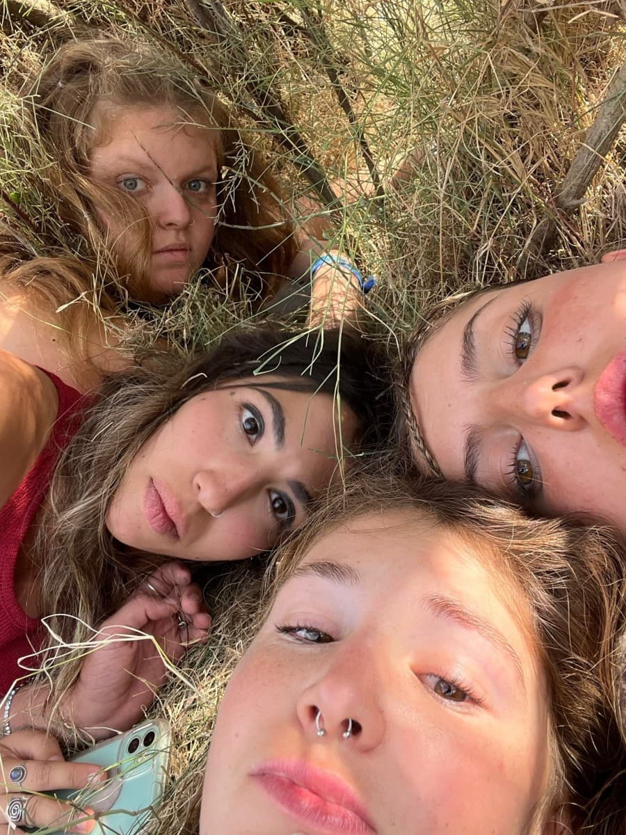 A group of four women looking directly at a camera that is directed from above.